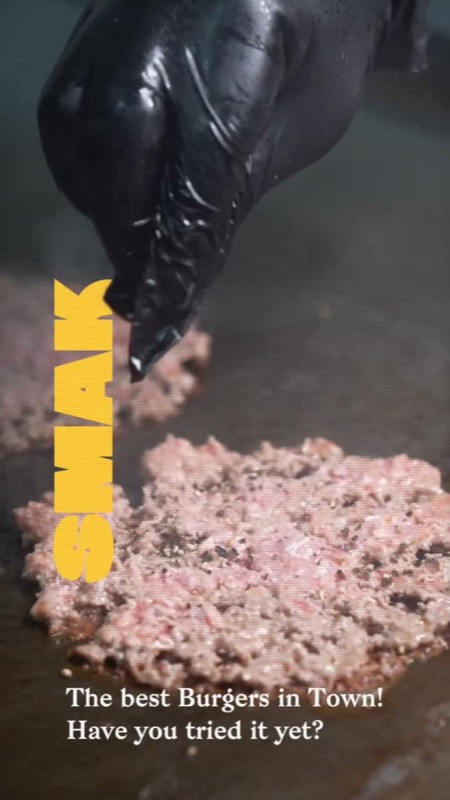 Smashing a fresh patty on the griddle
